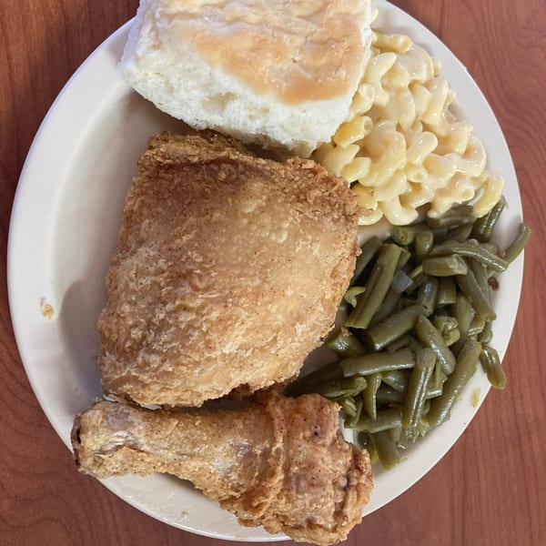 Barge Inn's fried chicken, macaroni and cheese, green beans, and a biscuit on a white plate.