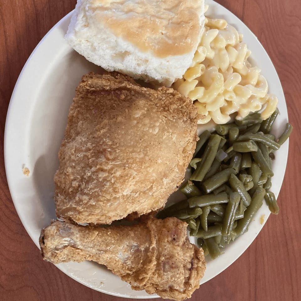 A plate of fried chicken, green beans, macaroni and cheese, and a biscuit from Barge Inn.